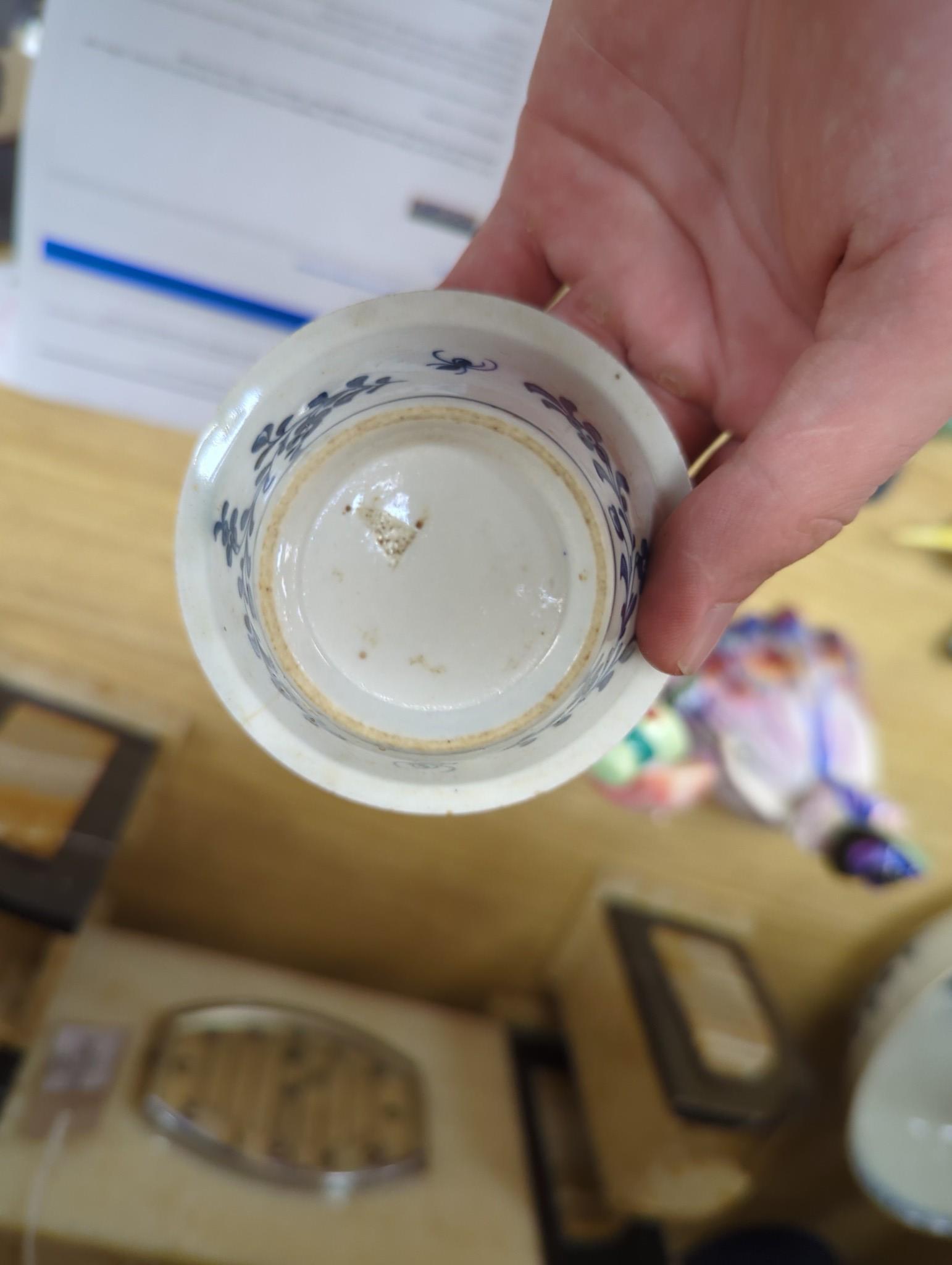 A large group of 18th century Worcester, Caughley and Liverpool blue and white tea bowls, coffee cups and saucers etc. including a Bow Cross-Legged Man